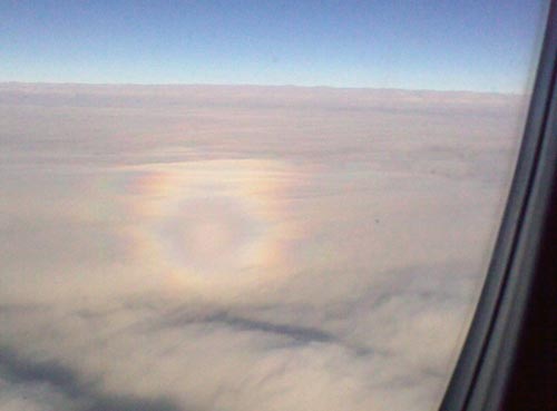 Glory rainbow around the shadow of an airplane